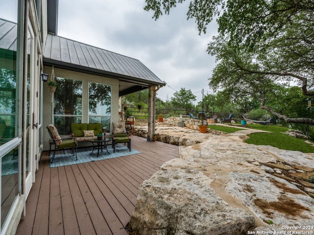 wooden deck featuring an outdoor hangout area