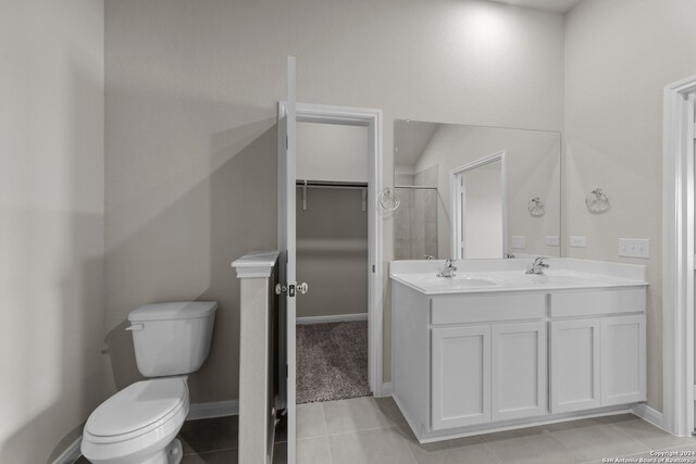 bathroom featuring tile patterned flooring, vanity, and toilet