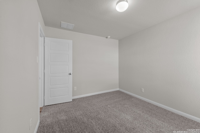 unfurnished room featuring carpet