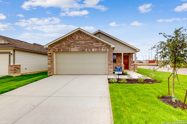 craftsman-style house with a front yard and a garage