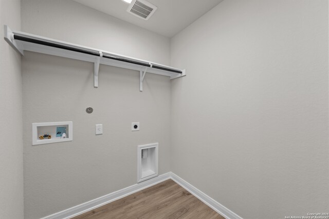 laundry area featuring electric dryer hookup, gas dryer hookup, hookup for a washing machine, and hardwood / wood-style floors