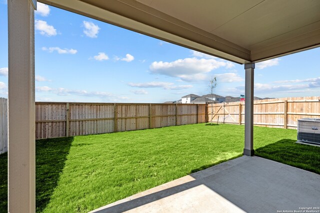 view of yard with a patio area and central air condition unit