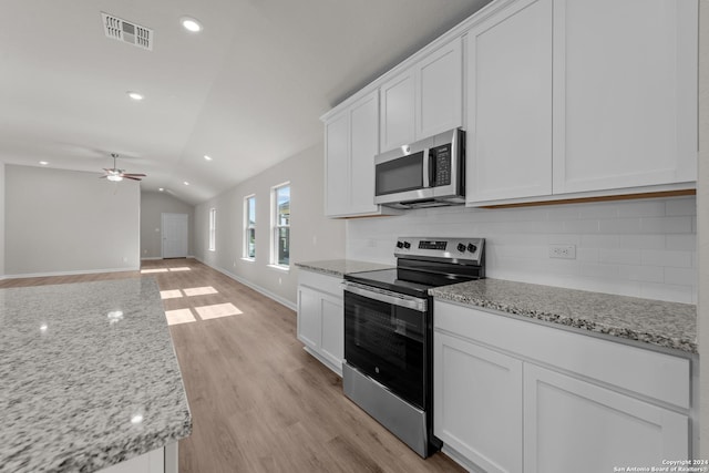 kitchen with white cabinetry, ceiling fan, vaulted ceiling, and appliances with stainless steel finishes