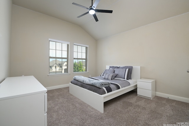 carpeted bedroom with ceiling fan and lofted ceiling