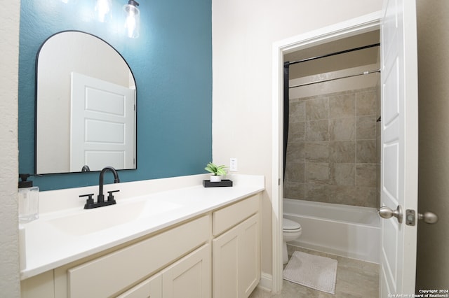 full bathroom featuring tile patterned flooring, vanity, tiled shower / bath combo, and toilet