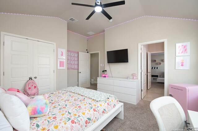 carpeted bedroom with ceiling fan, a closet, and lofted ceiling