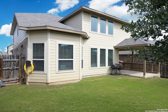 rear view of property with a lawn and a patio area