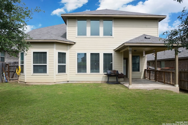 back of property with a patio and a lawn