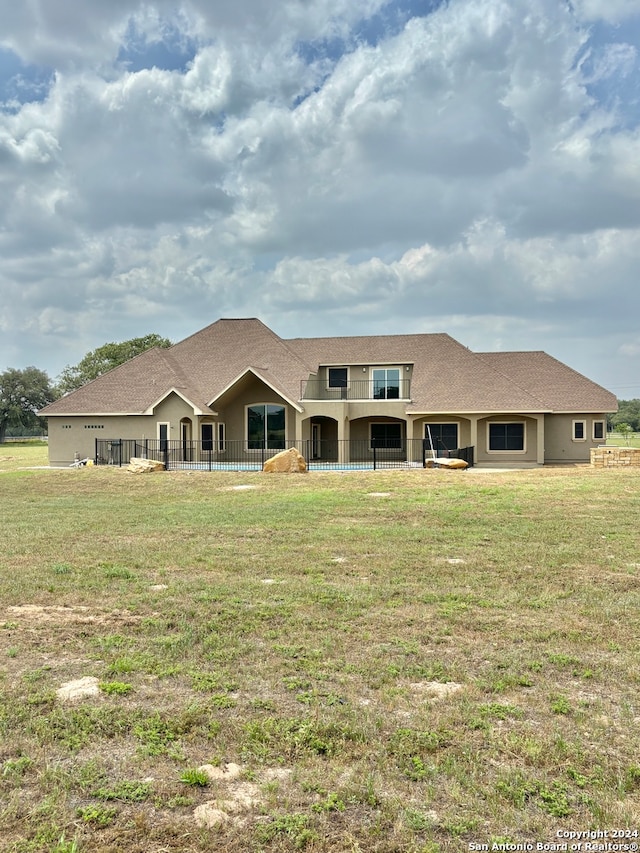 rear view of property featuring a yard