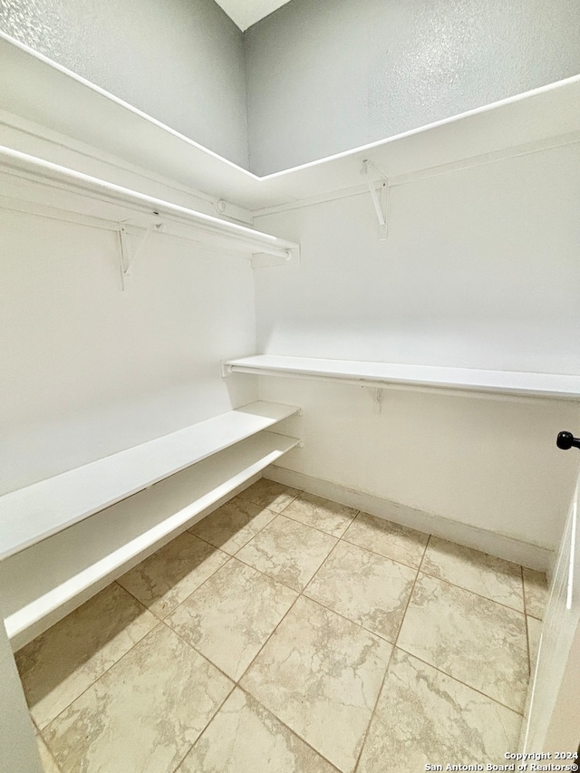 walk in closet featuring tile patterned flooring