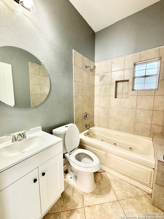 full bathroom with tile patterned floors, tiled shower / bath combo, vanity, and toilet