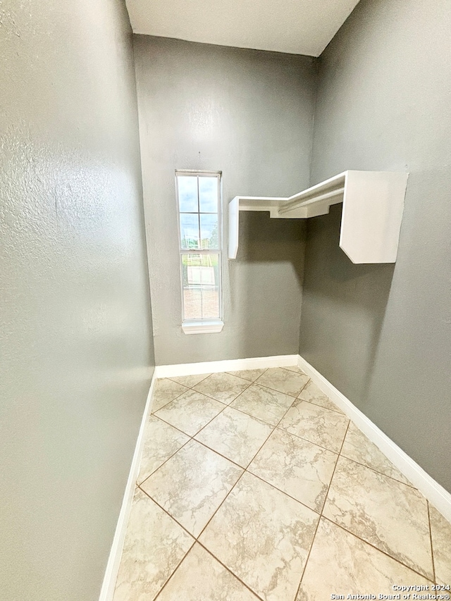 spacious closet with light tile patterned floors