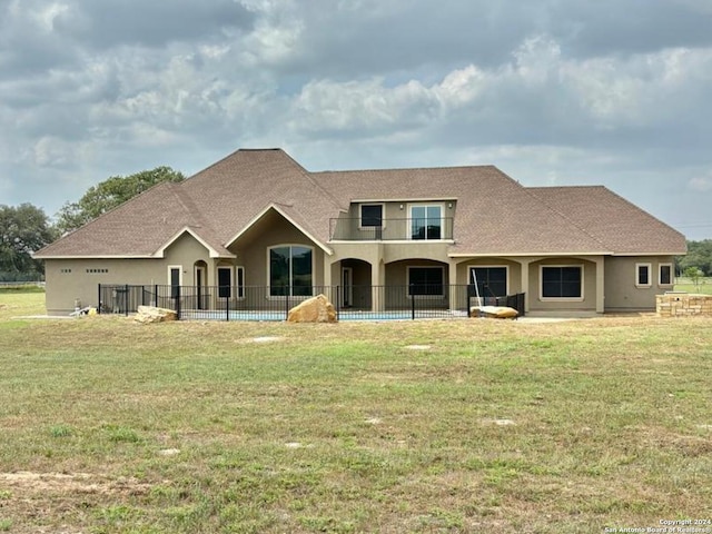 rear view of property with a yard and a patio area