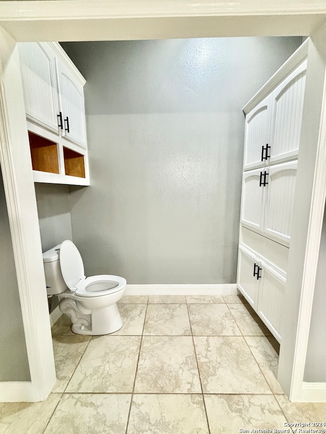 bathroom with tile patterned flooring and toilet