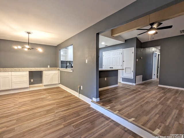 unfurnished living room featuring ceiling fan and hardwood / wood-style floors