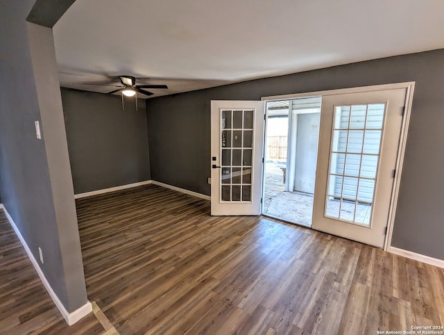 empty room with ceiling fan and dark wood-type flooring