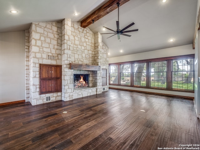 unfurnished living room with a stone fireplace, a healthy amount of sunlight, dark wood-type flooring, and ceiling fan