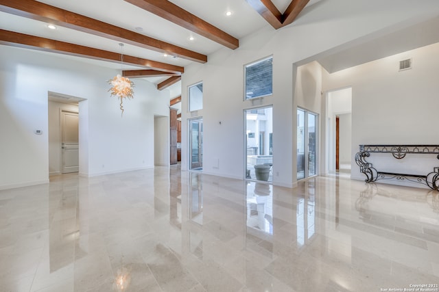 living room with beam ceiling and light tile flooring