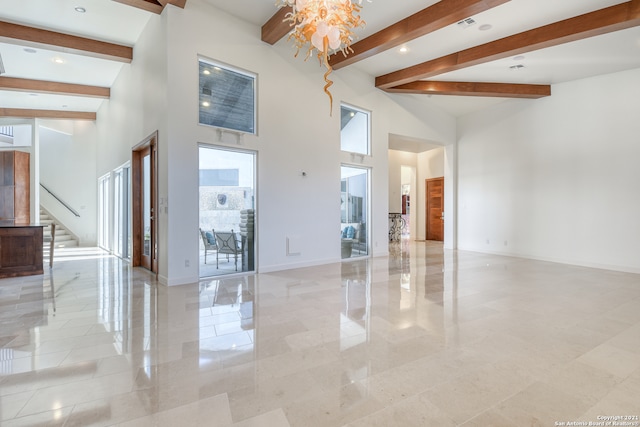 unfurnished room with an inviting chandelier, beamed ceiling, and light tile floors