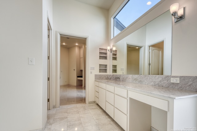 bathroom featuring tile floors, vanity, and a high ceiling