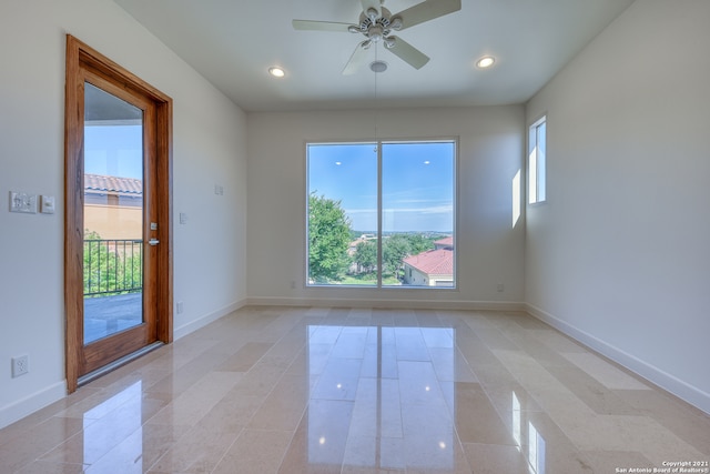 unfurnished room featuring ceiling fan and light tile flooring