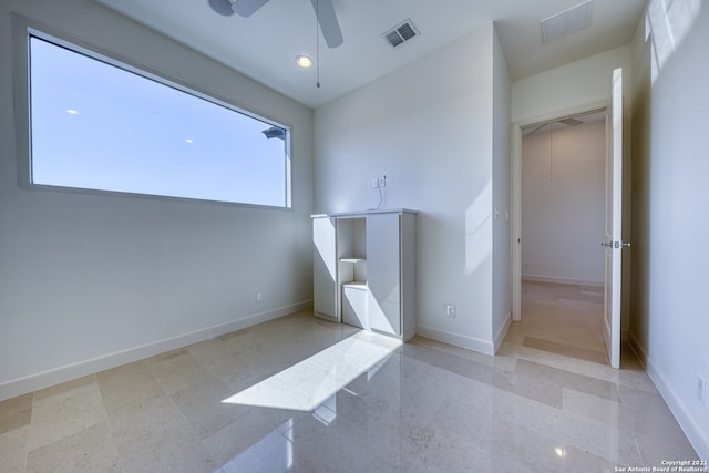 interior space with tile flooring and ceiling fan