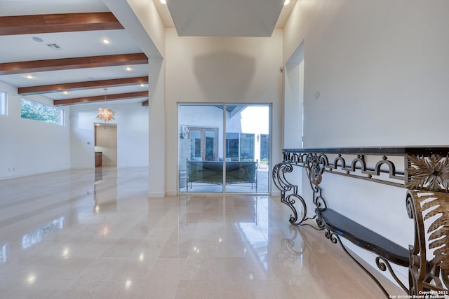 interior space featuring lofted ceiling with beams and light tile floors