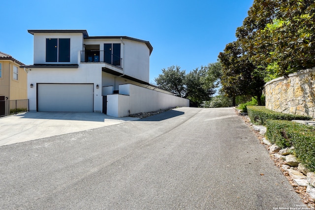 view of front of home with a garage and a balcony