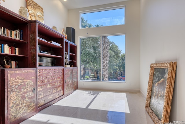 interior space with a high ceiling and tile floors