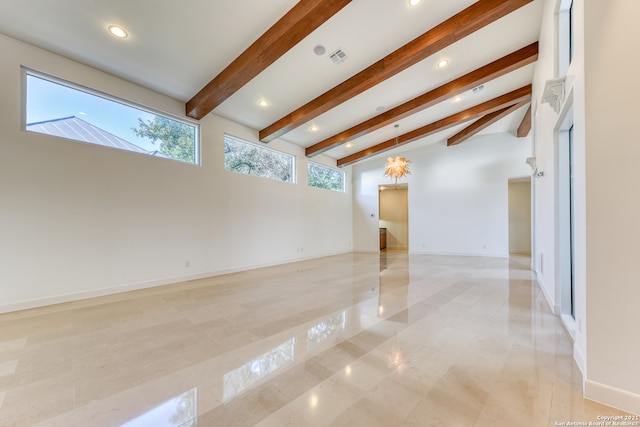 unfurnished living room with lofted ceiling with beams and light tile flooring