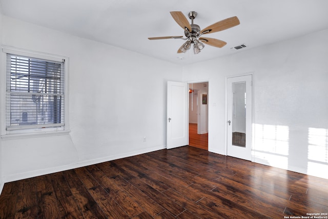 spare room featuring dark wood-type flooring and ceiling fan