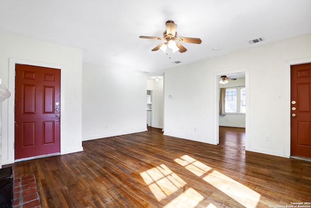 unfurnished living room featuring ceiling fan and dark hardwood / wood-style floors