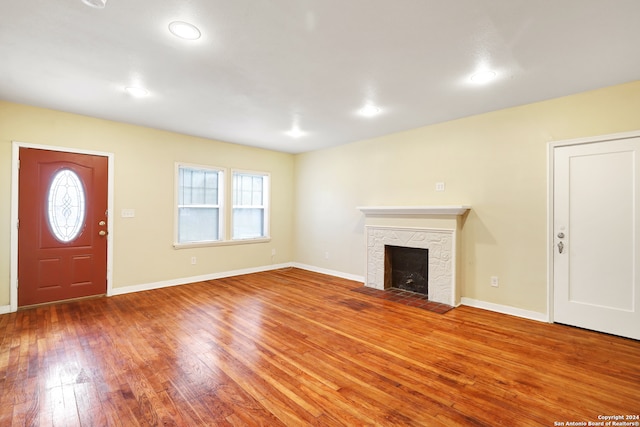 foyer entrance featuring a wealth of natural light, a fireplace, and hardwood / wood-style floors