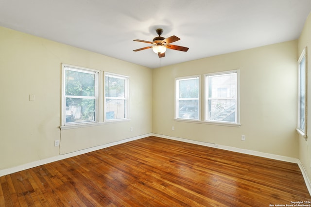 unfurnished room with ceiling fan and hardwood / wood-style flooring