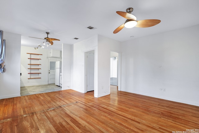 empty room featuring ceiling fan and light hardwood / wood-style flooring