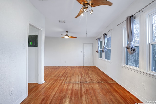 empty room with ceiling fan and light wood-type flooring