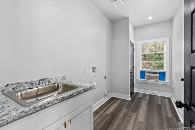 laundry area with cabinets, dark wood-type flooring, washer hookup, electric dryer hookup, and sink