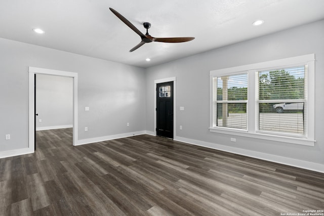 unfurnished room with dark hardwood / wood-style floors and ceiling fan