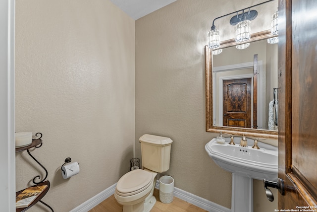 bathroom with wood-type flooring and toilet