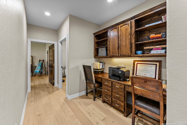 office area featuring built in desk, built in features, and light hardwood / wood-style flooring