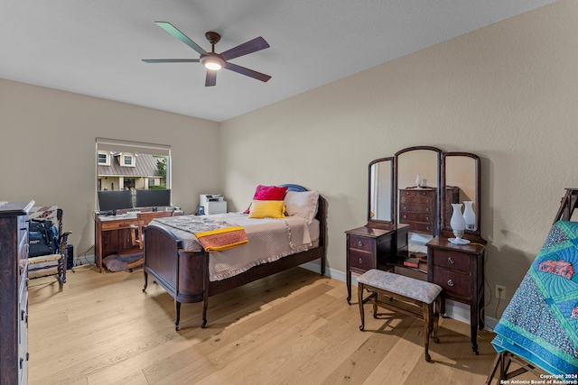 bedroom with ceiling fan and light wood-type flooring