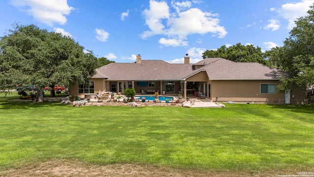 back of property featuring a patio and a yard