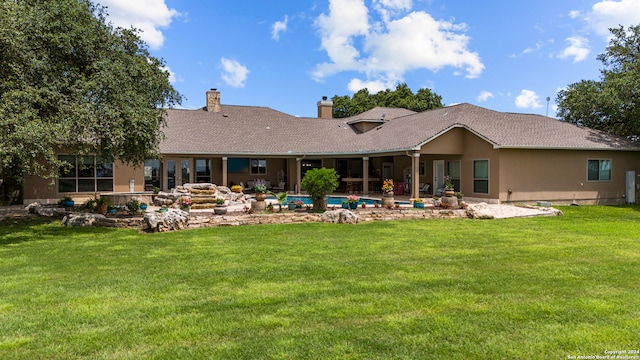 back of house with a patio and a yard