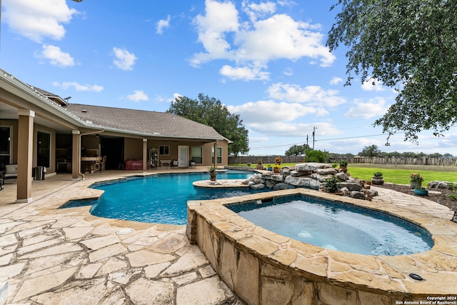 view of pool featuring an in ground hot tub and a patio