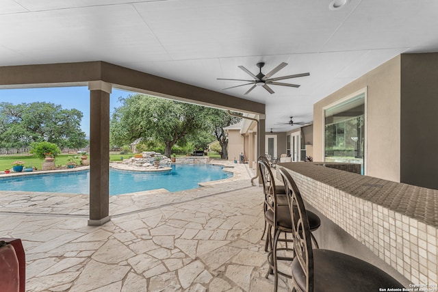 view of pool with a patio and ceiling fan