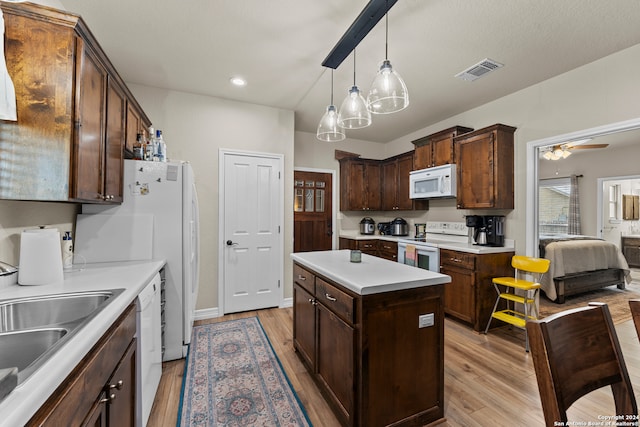 kitchen with light hardwood / wood-style flooring, white appliances, decorative light fixtures, dark brown cabinetry, and ceiling fan