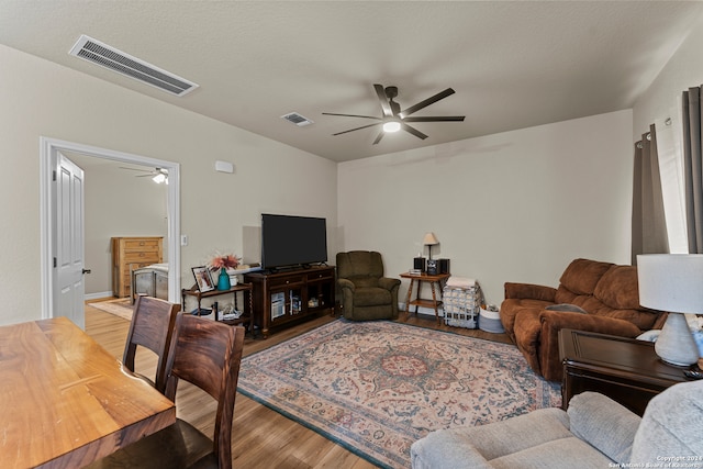 living room featuring ceiling fan and hardwood / wood-style floors