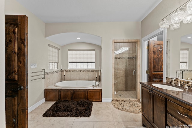 bathroom with tile floors, separate shower and tub, and large vanity