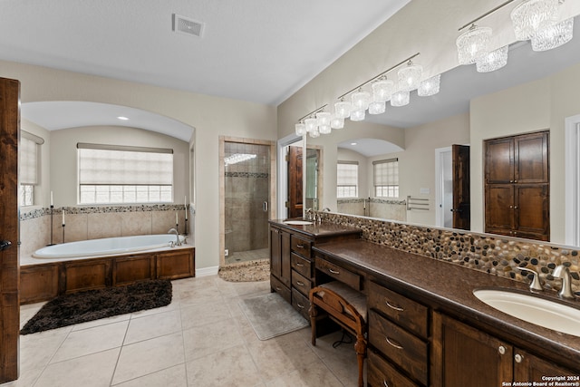 bathroom featuring tile floors, separate shower and tub, and vanity