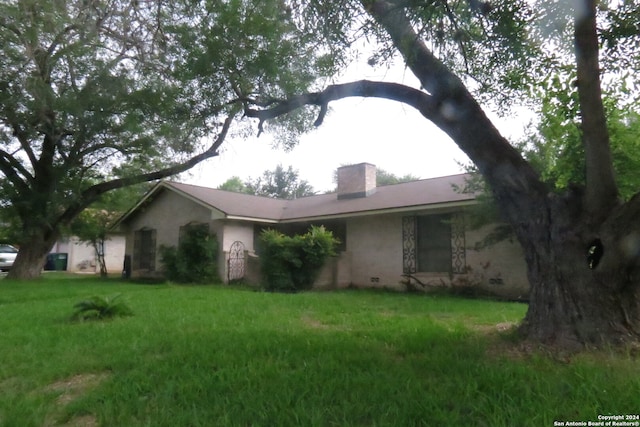 view of home's exterior with a lawn